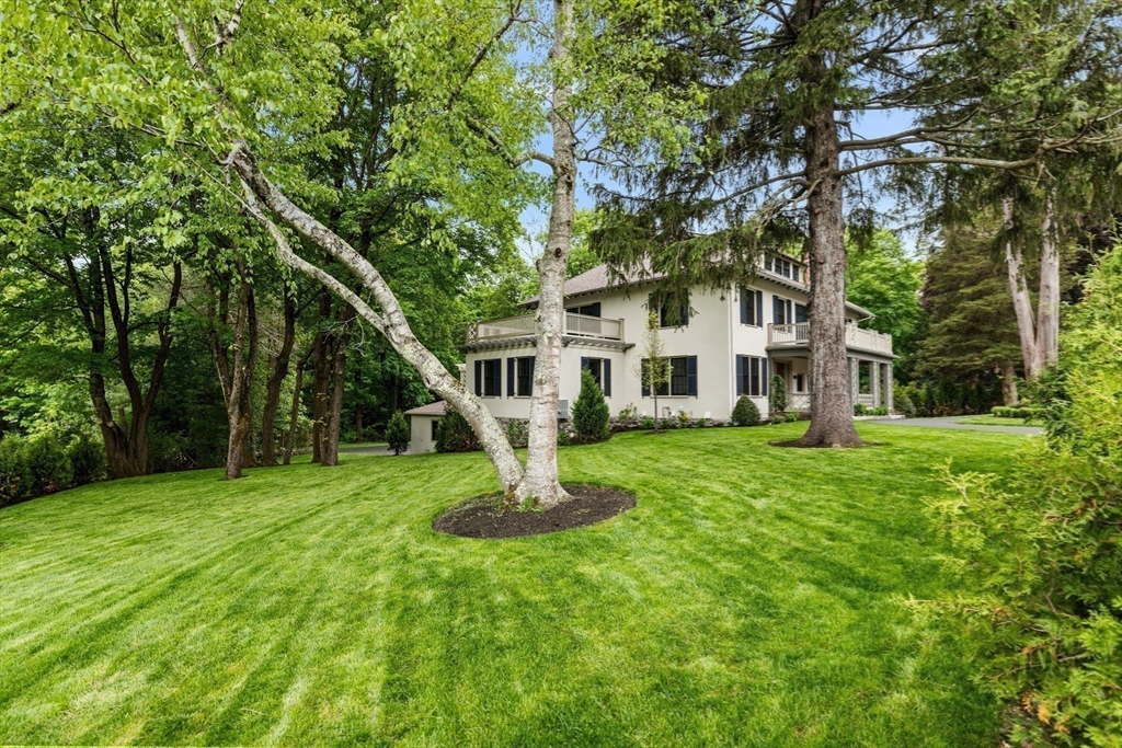 2 Percy Road Lexington, MA 02421 - Photo 29 of 31 a white house that has a tree in front of a house