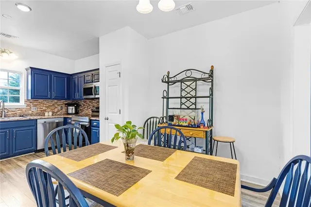 a kitchen with stainless steel appliances a refrigerator and a stove top oven