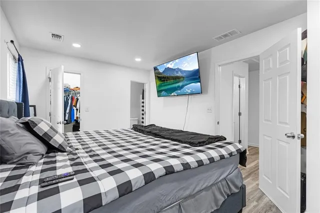 a bedroom with a large bed and a window