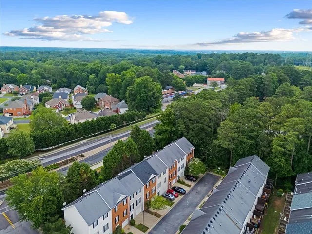 a aerial view of a brick house many windows and a table and chairs