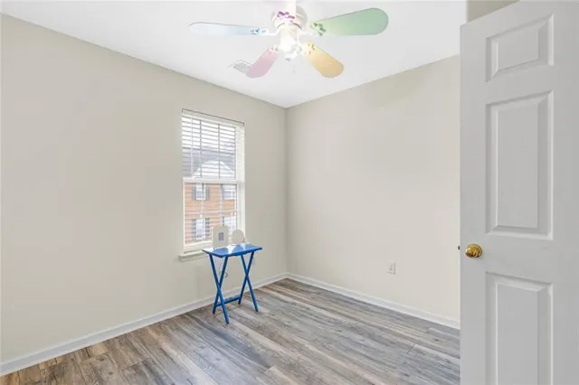 a view of a room with a window and wooden floor