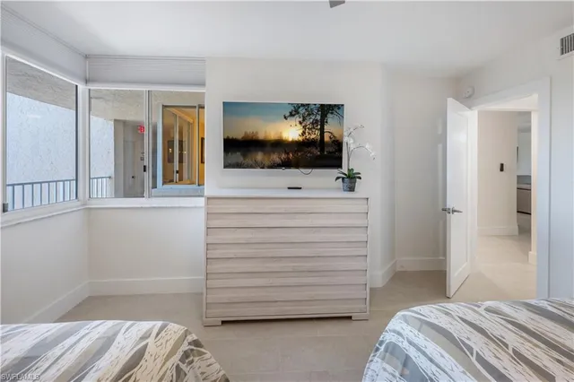 a room with a bed and a television