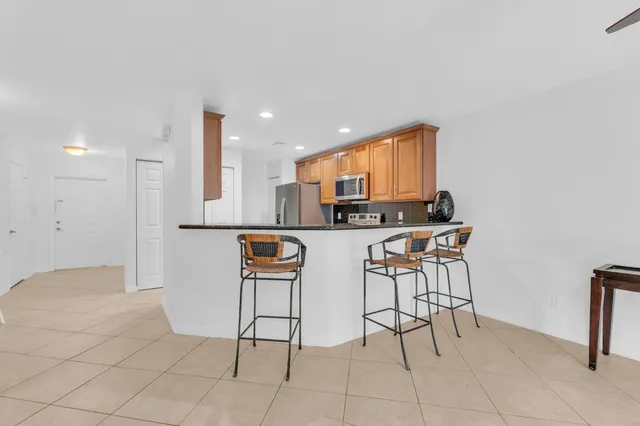 a kitchen with stainless steel appliances kitchen island granite countertop a sink and cabinets