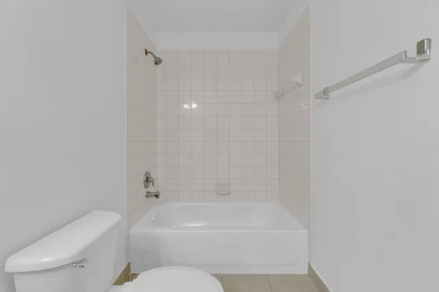 a white bath tub sitting next to a white toilet