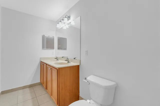 a bathroom with a sink toilet and mirror
