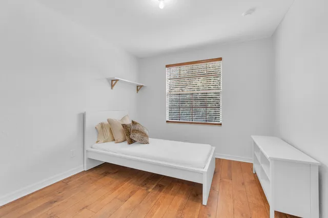 a bedroom with a bed and window