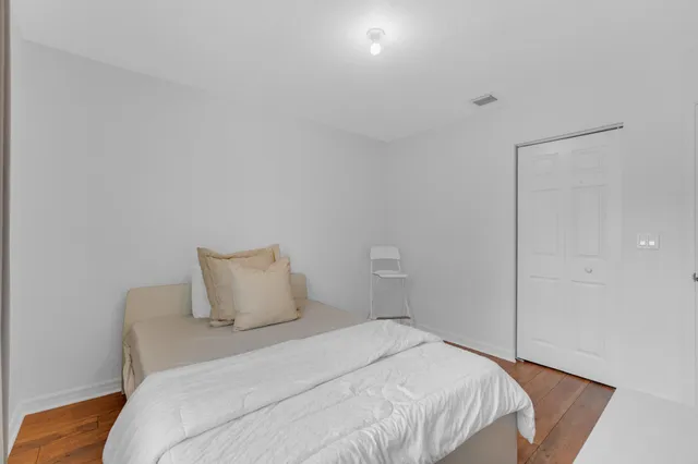 a bedroom with a bed and a closet