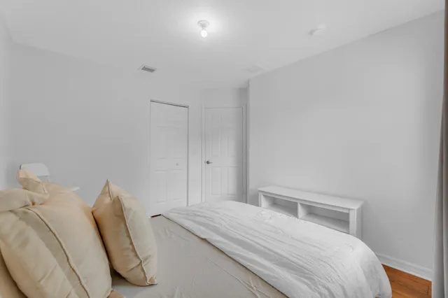 a bedroom with a bed and a chair