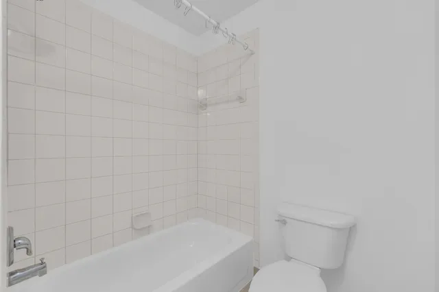 a bathroom with a bathtub and toilet