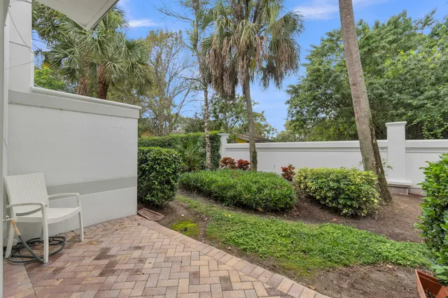 a view of backyard with outdoor seating and green space