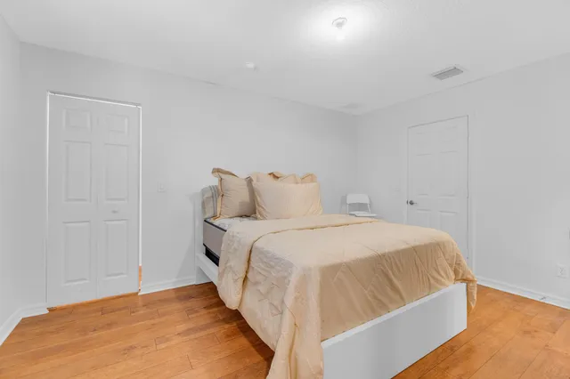 a bedroom with a bed and a night stand