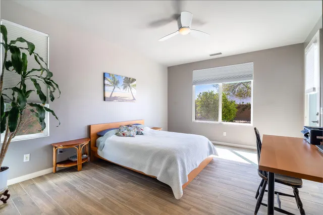a bedroom with a bed and a potted plant