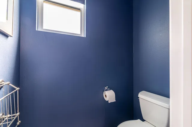 a toilet with a toilet and a window