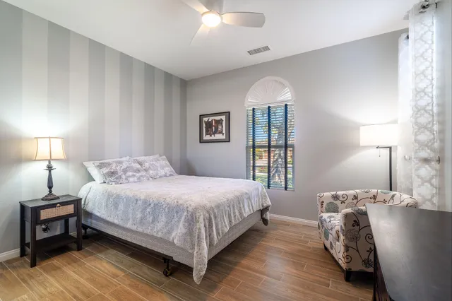 a bedroom with a bed and a mirror