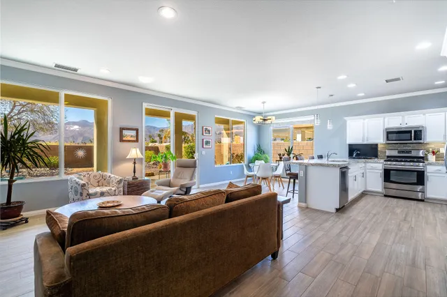 a living room with furniture and large windows