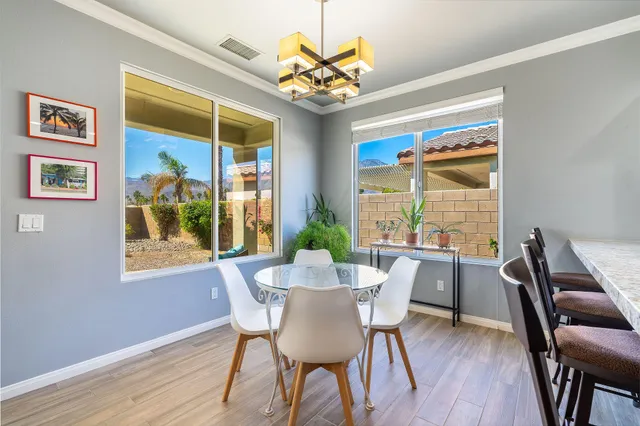 a view of a dining room with furniture wooden floor and a chandelier