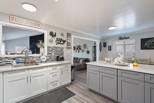a kitchen with counter top space sink and stove