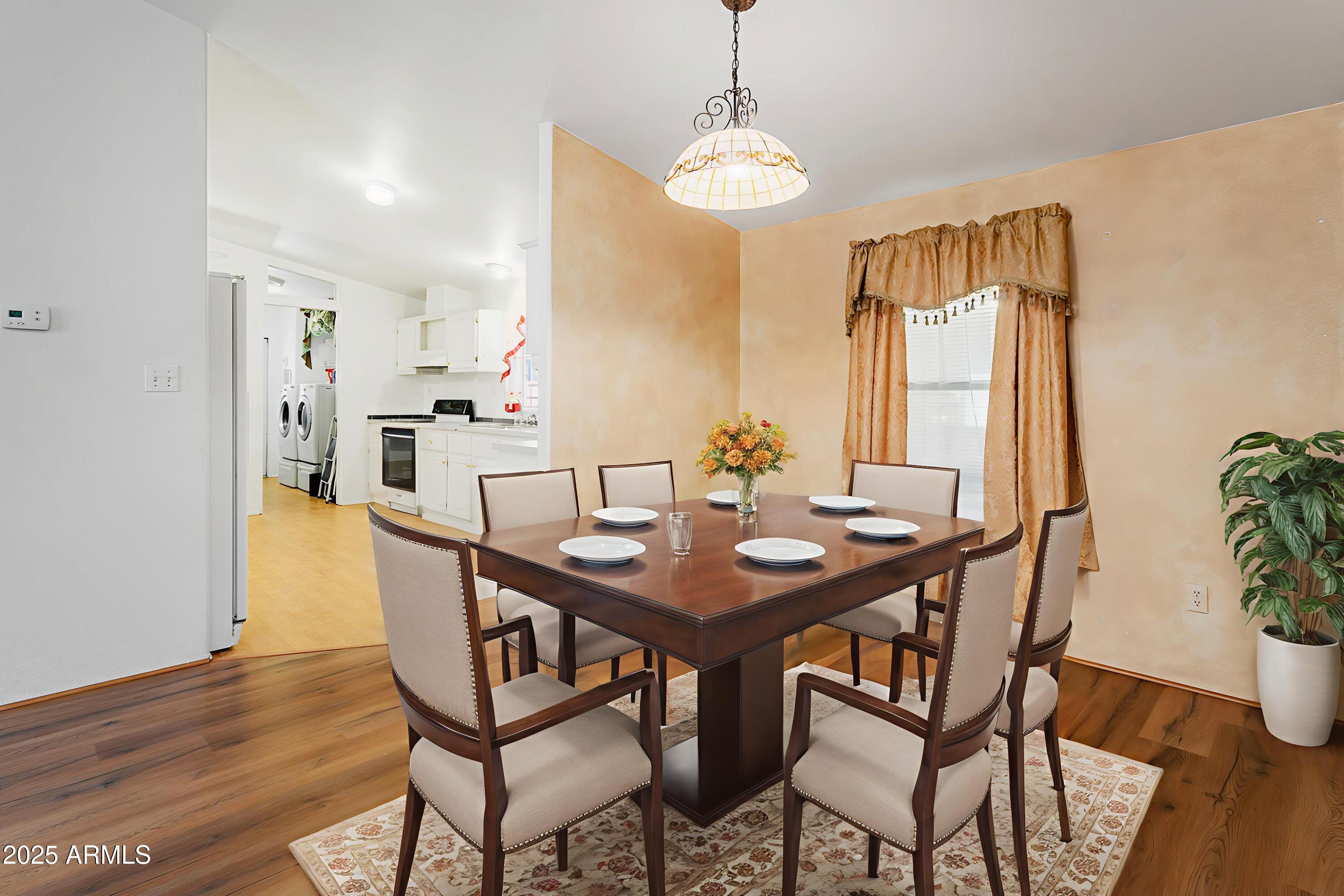 16416 North 33rd Way Phoenix, AZ 85032 - Photo 10 of 31 a view of a dining room with furniture and wooden floor