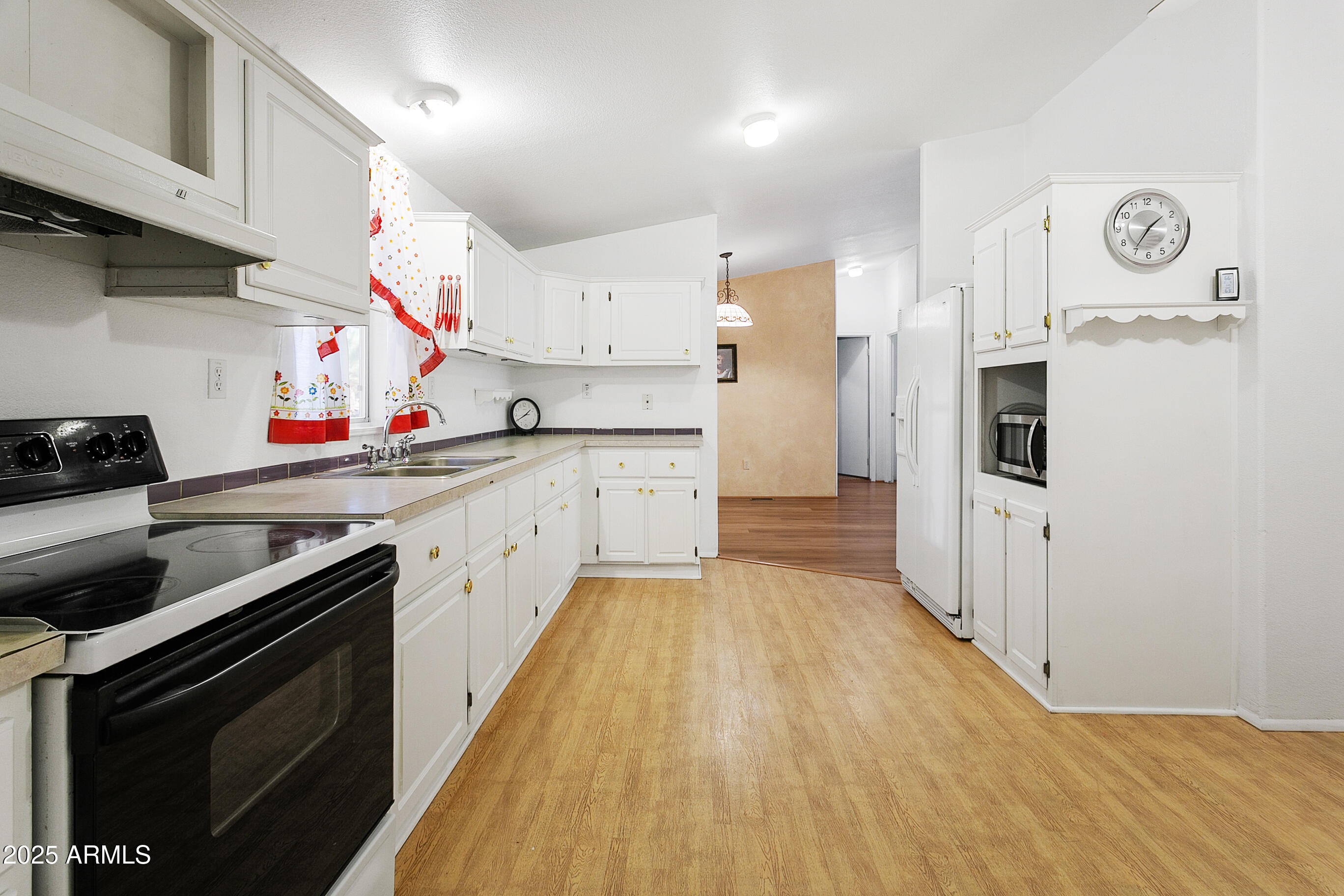16416 North 33rd Way Phoenix, AZ 85032 - Photo 13 of 31 a kitchen with stainless steel appliances a sink dishwasher stove and white cabinets