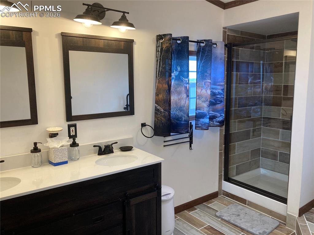 136 Black Knat Road Fairplay, CO 80440 - Photo 12 of 38 a bathroom with a double vanity sink mirror and shower