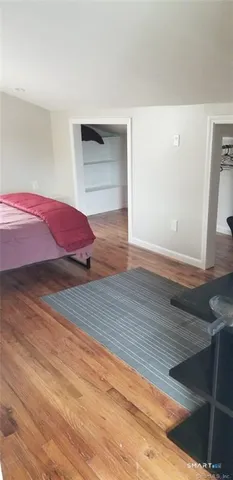 a bedroom with a bed and a mirror