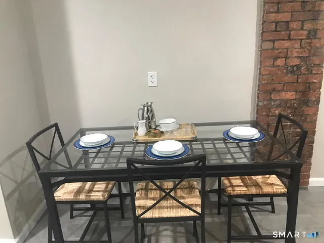 a view of a dining room with furniture and wooden floor