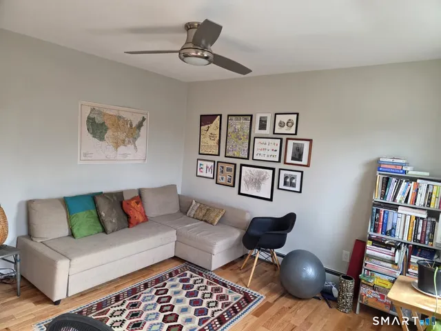 a living room with furniture and a book shelf