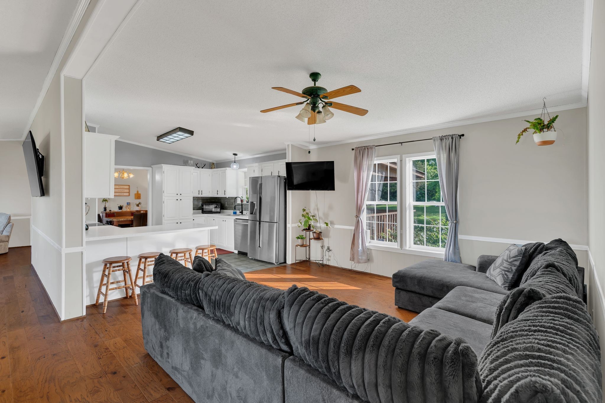 a living room with furniture fireplace and flat screen tv