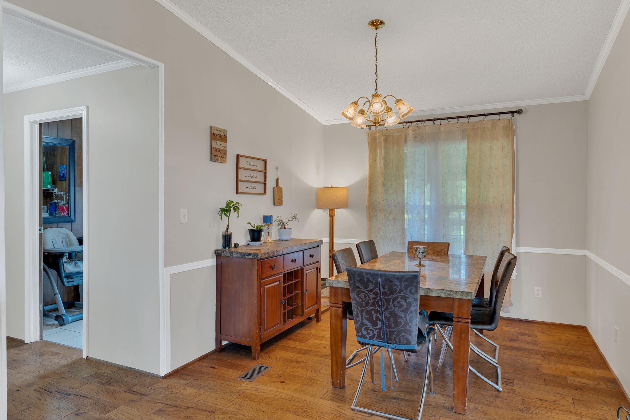 960 Harsh Lane Castalian Springs, TN 37031 - Photo 14 of 51 a view of a dining room with furniture wooden floor and a chandelier