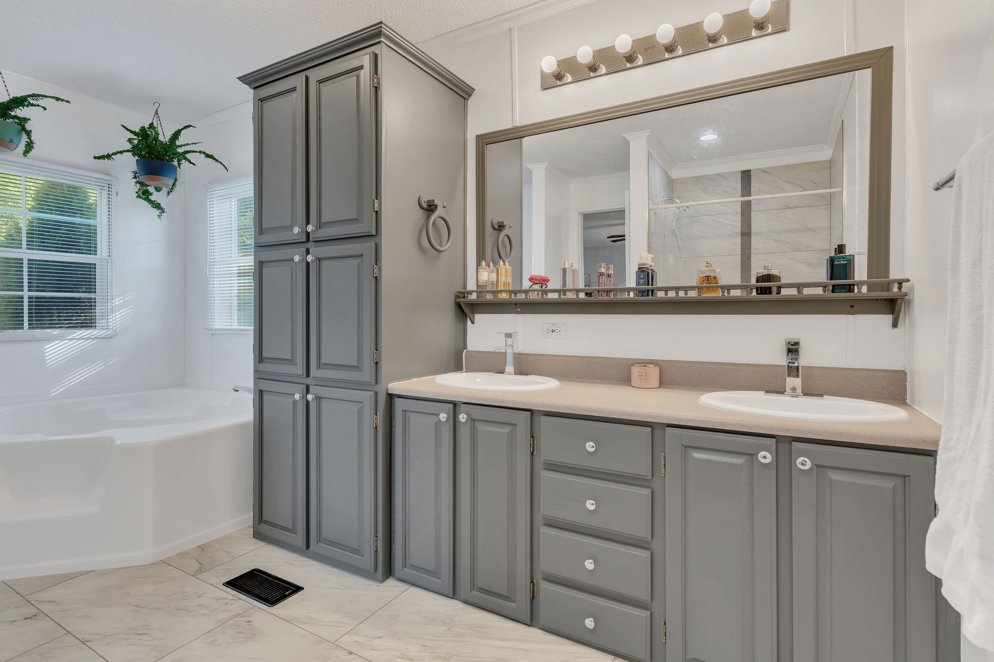 960 Harsh Lane Castalian Springs, TN 37031 - Photo 21 of 51 a bathroom with a double vanity sink a mirror and a bathtub