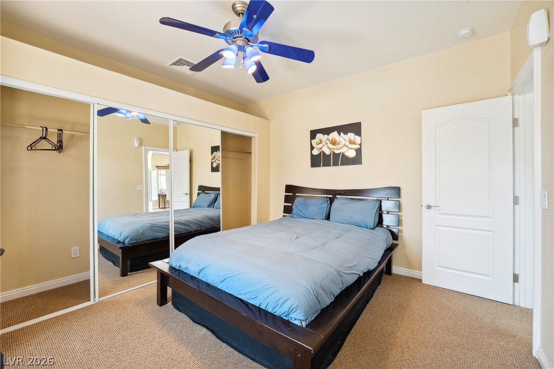 2181 Winery Road Pahrump, NV 89048 - Photo 39 of 52 A comfortable sleeping area offers mirrored closet doors and a ceiling fan for year-round comfort.