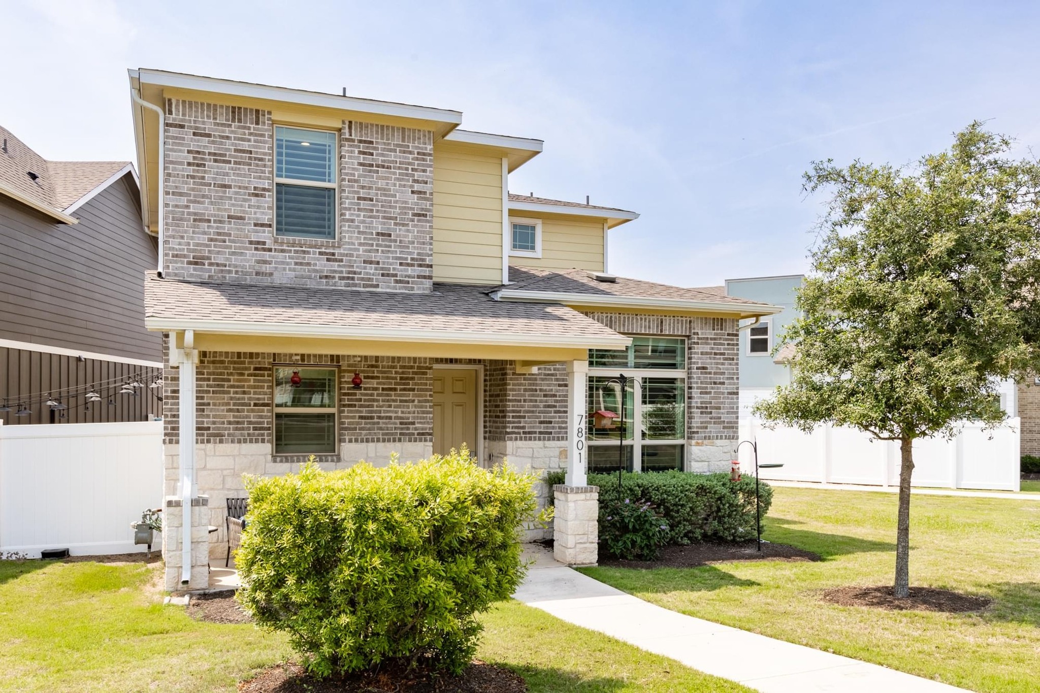 7801 Frida Bend Austin, TX 78744 - Photo 26 of 26 A well-kept front yard and inviting porch define this charming two-story residence.