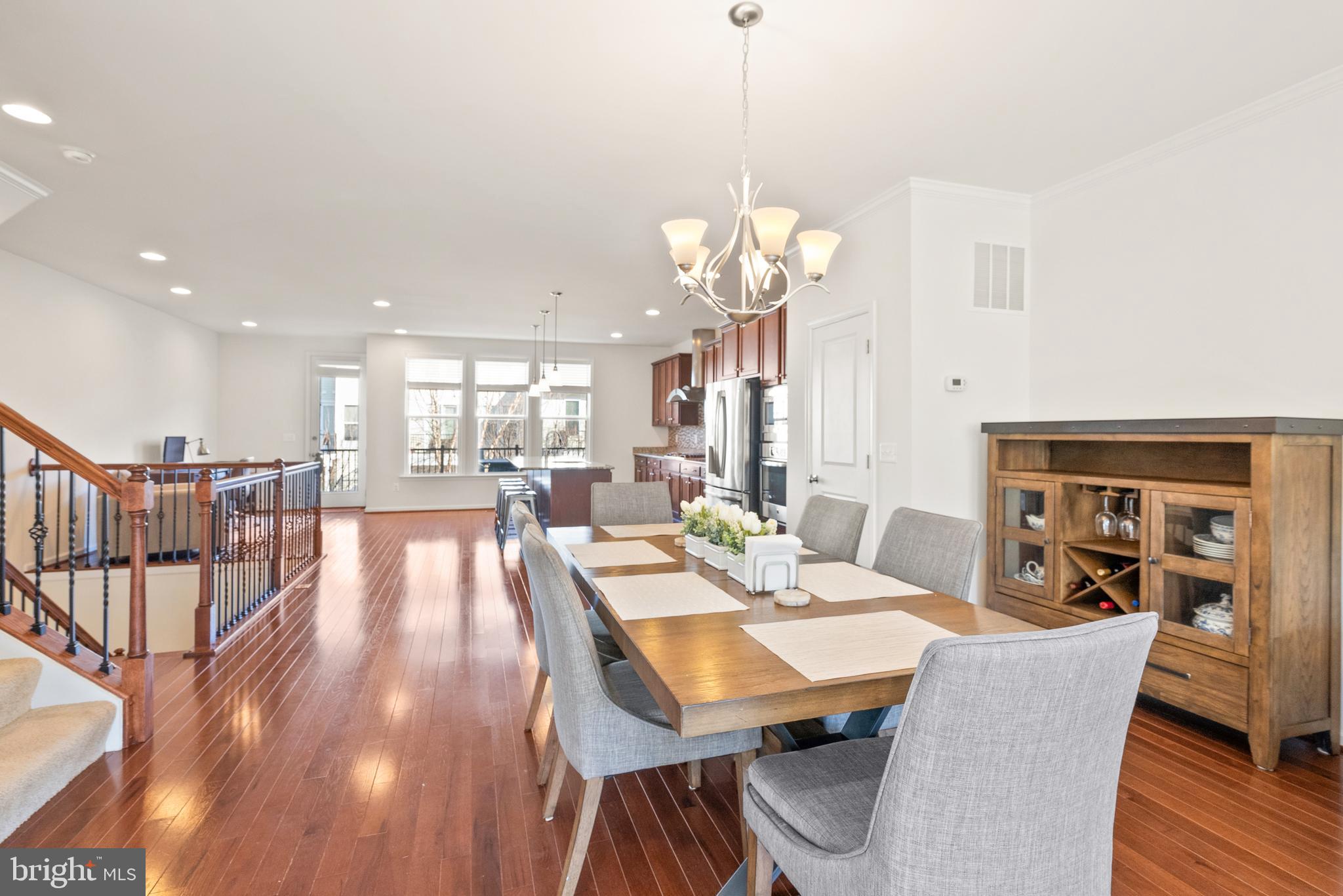 42274 Riggins Ridge Terrace Brambleton, VA 20148 - Photo 17 of 56 a view of a dining room and livingroom with furniture wooden floor a chandelier