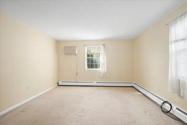 a view of an empty room with glass door