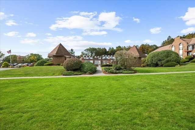 a view of a field with houses in the background