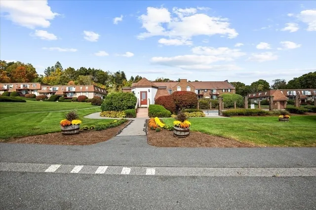 a view of a street with cars parked on the road