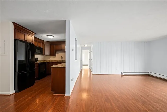 a bathroom with a granite countertop sink and a window