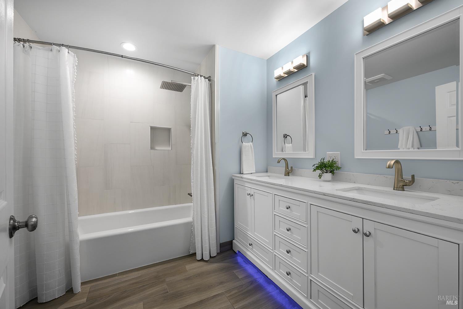 5313 Yerba Buena Road Santa Rosa, CA 95409 - Photo 13 of 34 Beautifully updated primary bathroom features a dual-sink vanity, stone countertops, and a stylish tiled shower with modern fixtures.
