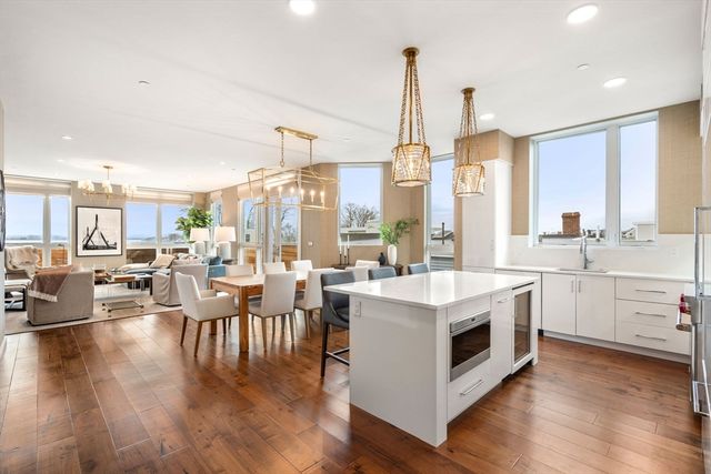 a open kitchen with white cabinets and white appliances