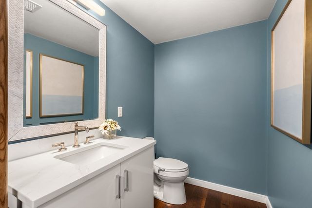 a bathroom with a sink toilet and mirror
