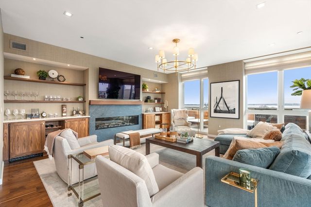 a living room with fireplace furniture and a flat screen tv