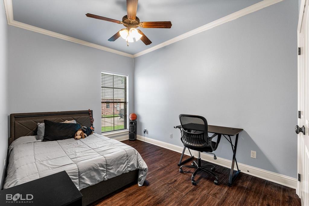 2220 Forest Hills Boulevard Haughton, LA 71037 - Photo 34 of 40 Bedroom featuring wood-finish flooring, a ceiling fan with integrated lighting, crown molding, and white baseboards