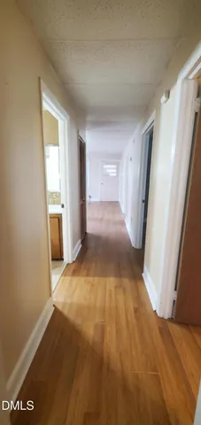 a view of hallway with wooden floor