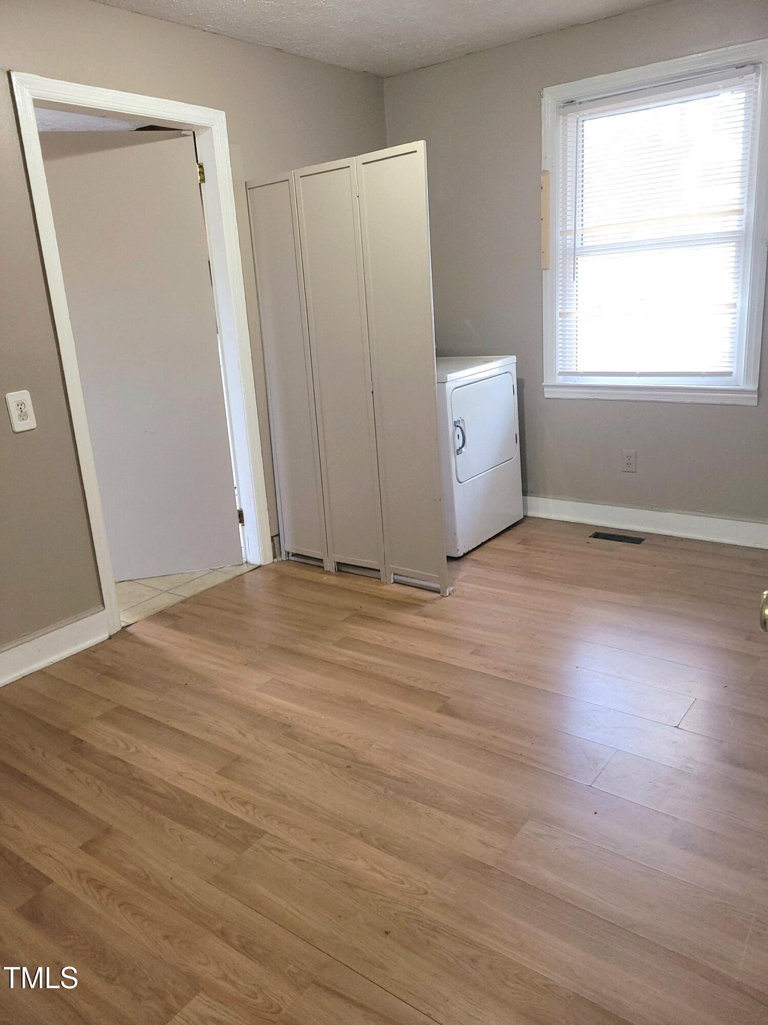 327 Ranch Farm Road Raleigh, NC 27603 - Photo 16 of 27 a view of an empty room with wooden floor and a window