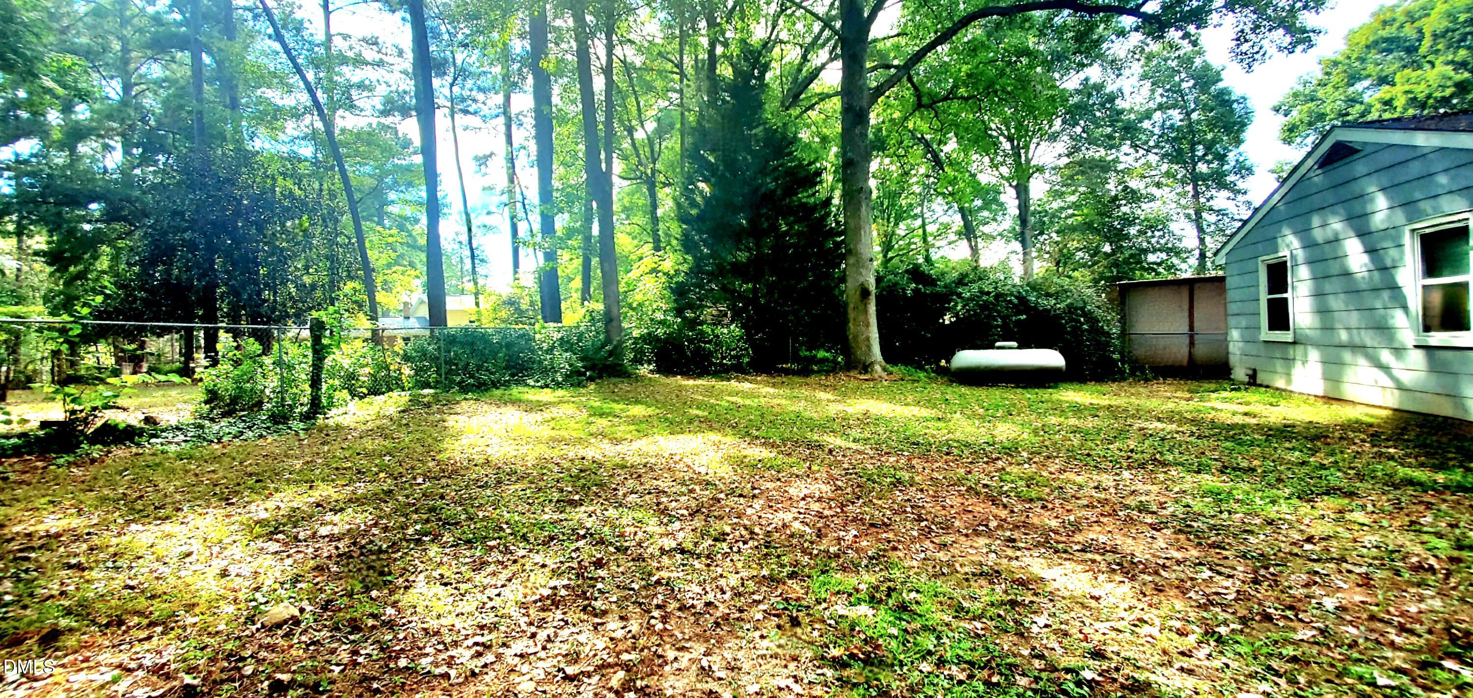 327 Ranch Farm Road Raleigh, NC 27603 - Photo 24 of 27 a view of a backyard with a garden and trees