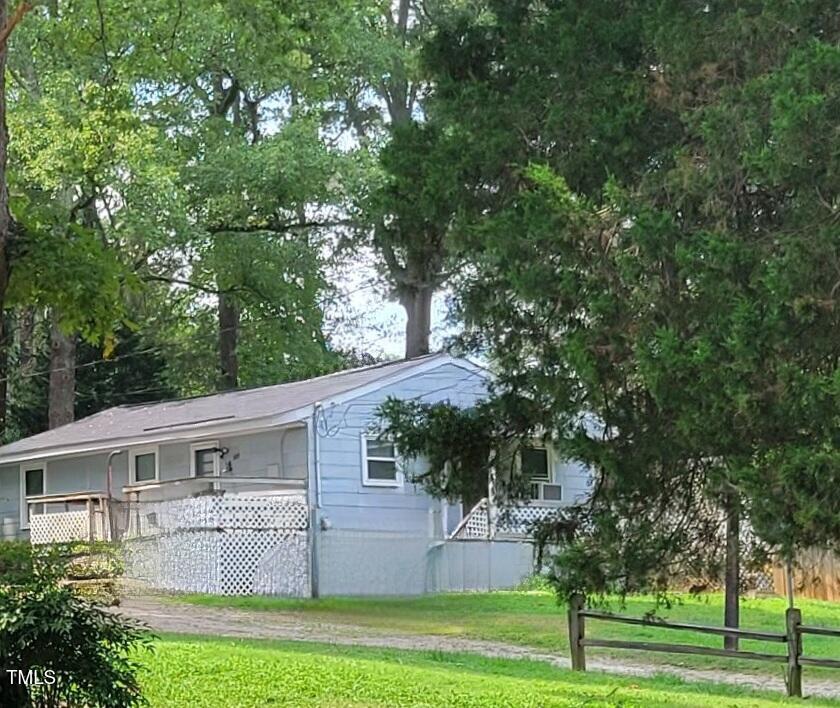 327 Ranch Farm Road Raleigh, NC 27603 - Photo 4 of 27 a view of a big house with a big yard and large trees