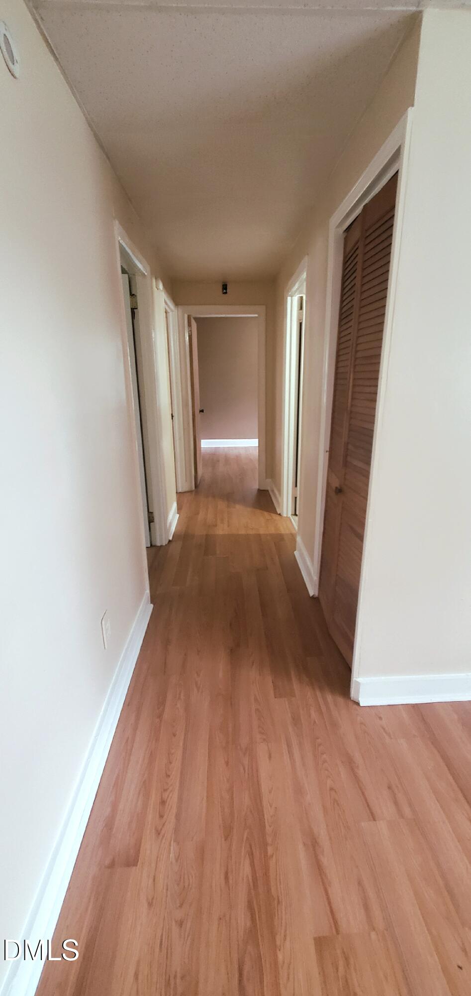 327 Ranch Farm Road Raleigh, NC 27603 - Photo 7 of 27 a view of a big room with wooden floor and staircase