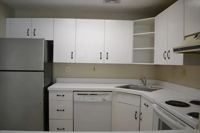 a view of cabinets a washer and dryer