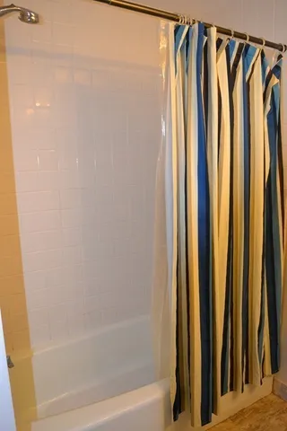 a bathroom with a shower and a tub