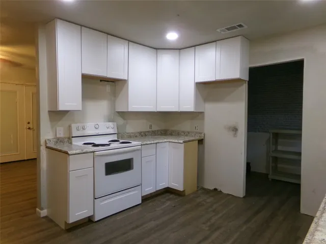 a kitchen with a stove a refrigerator and a sink